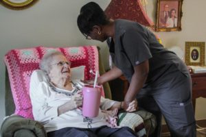 Nurse attends to woman in her room