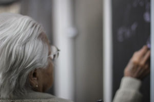 Assisted Care patient works on chalkboard