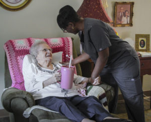 Nurse helping patient in her room