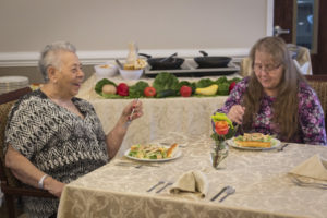 two women enjoy lunch in the Woodbury dining room