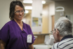 Nurse speaking with elderly man